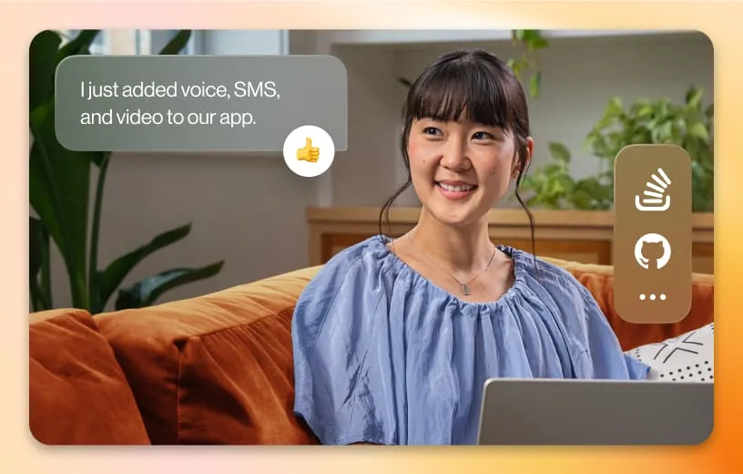 A woman holding her laptop while sitting on the couch saying "I just added voice, SMS, and video to our app."