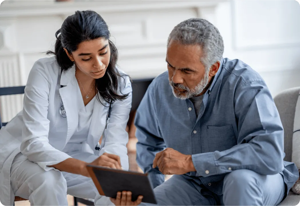 An eye doctor and patient review information on a tablet