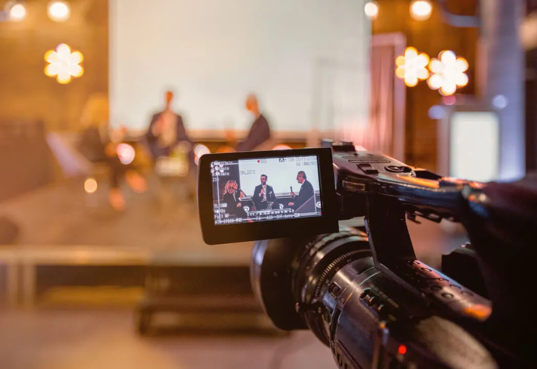 A video camera is actively recording a live event