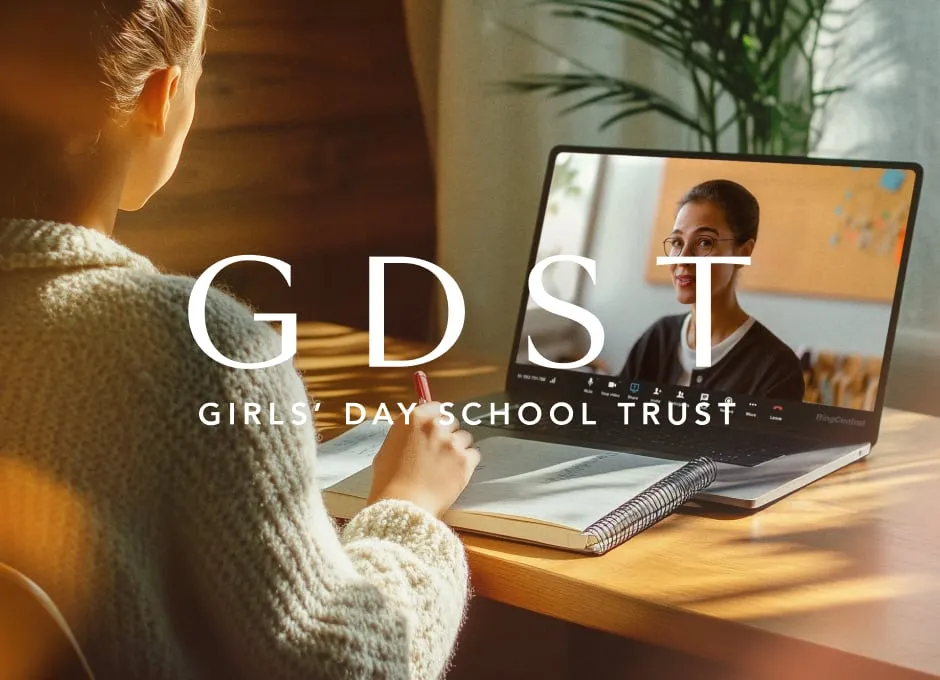 A girl takes notes while a teacher speaks on a video call