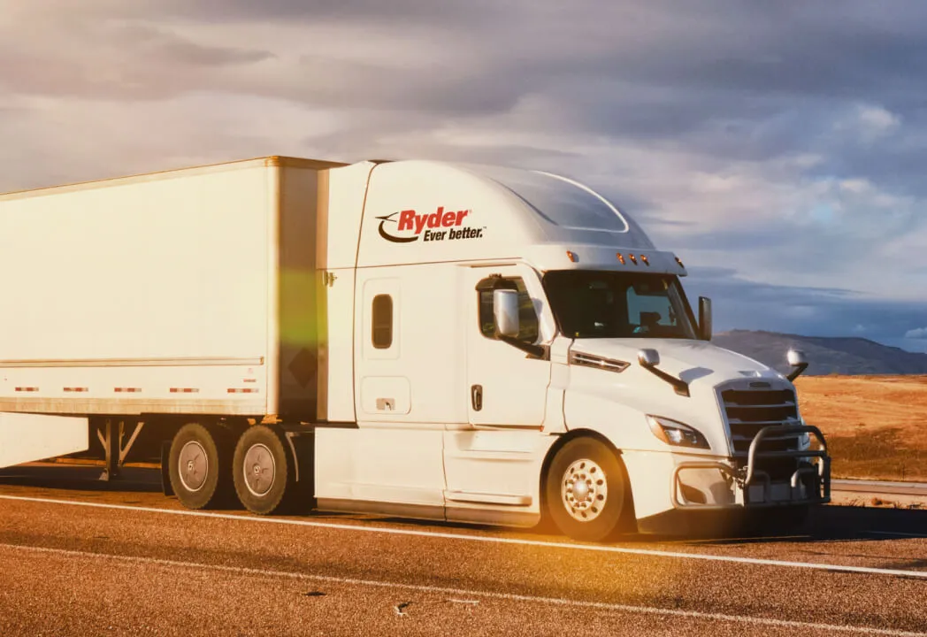 Ryder semi-truck traveling on a highway 