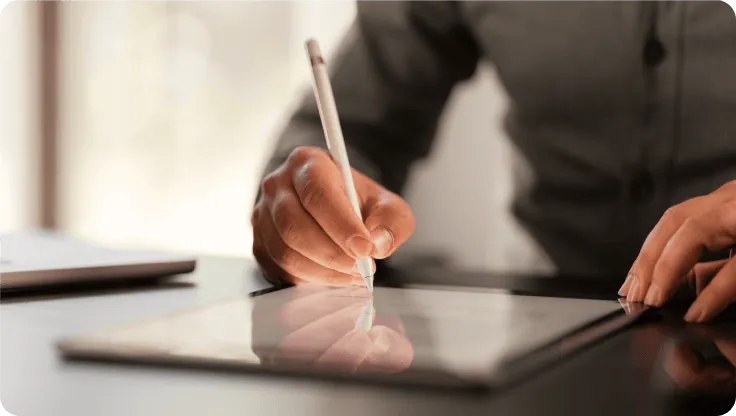A man writing on his tablet
